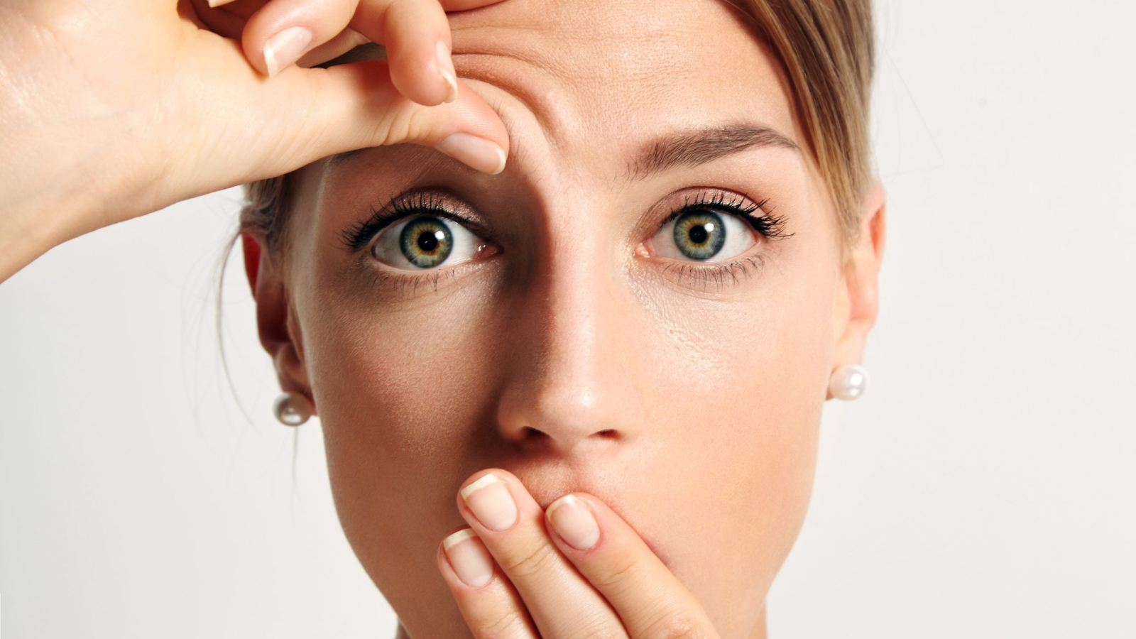 young girl wondering that hse have first wrinkle on her forehead