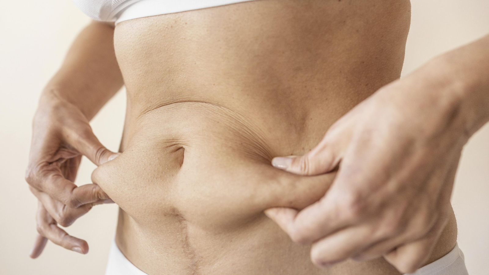 close-up-hands-holding-belly