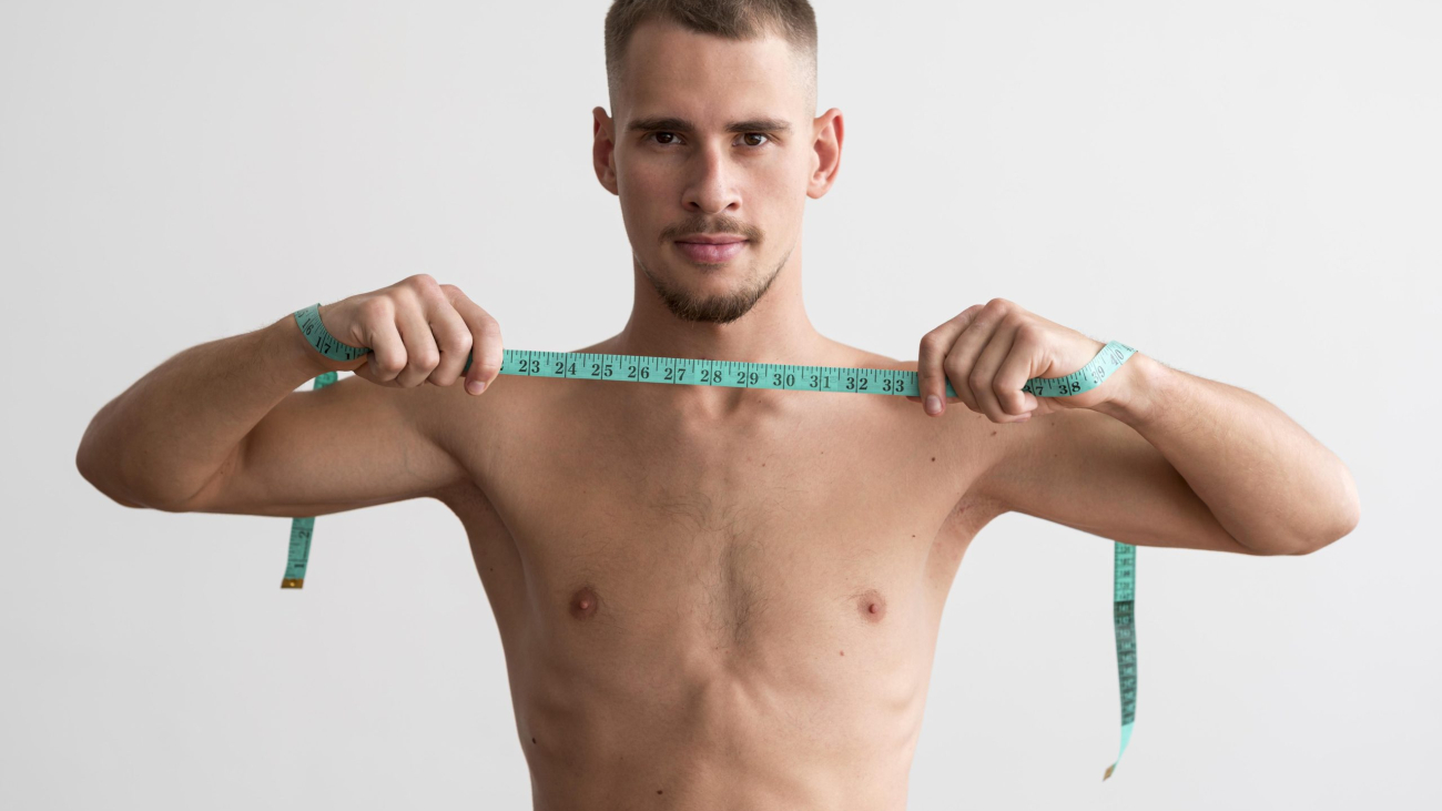 shirtless-man-holding-measuring-tape