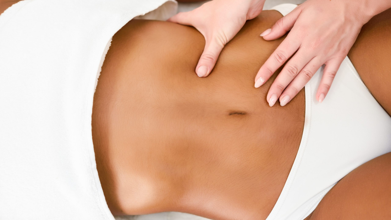 Woman receiving abdomen massage in spa wellness center. Beauty and Aesthetic concepts.