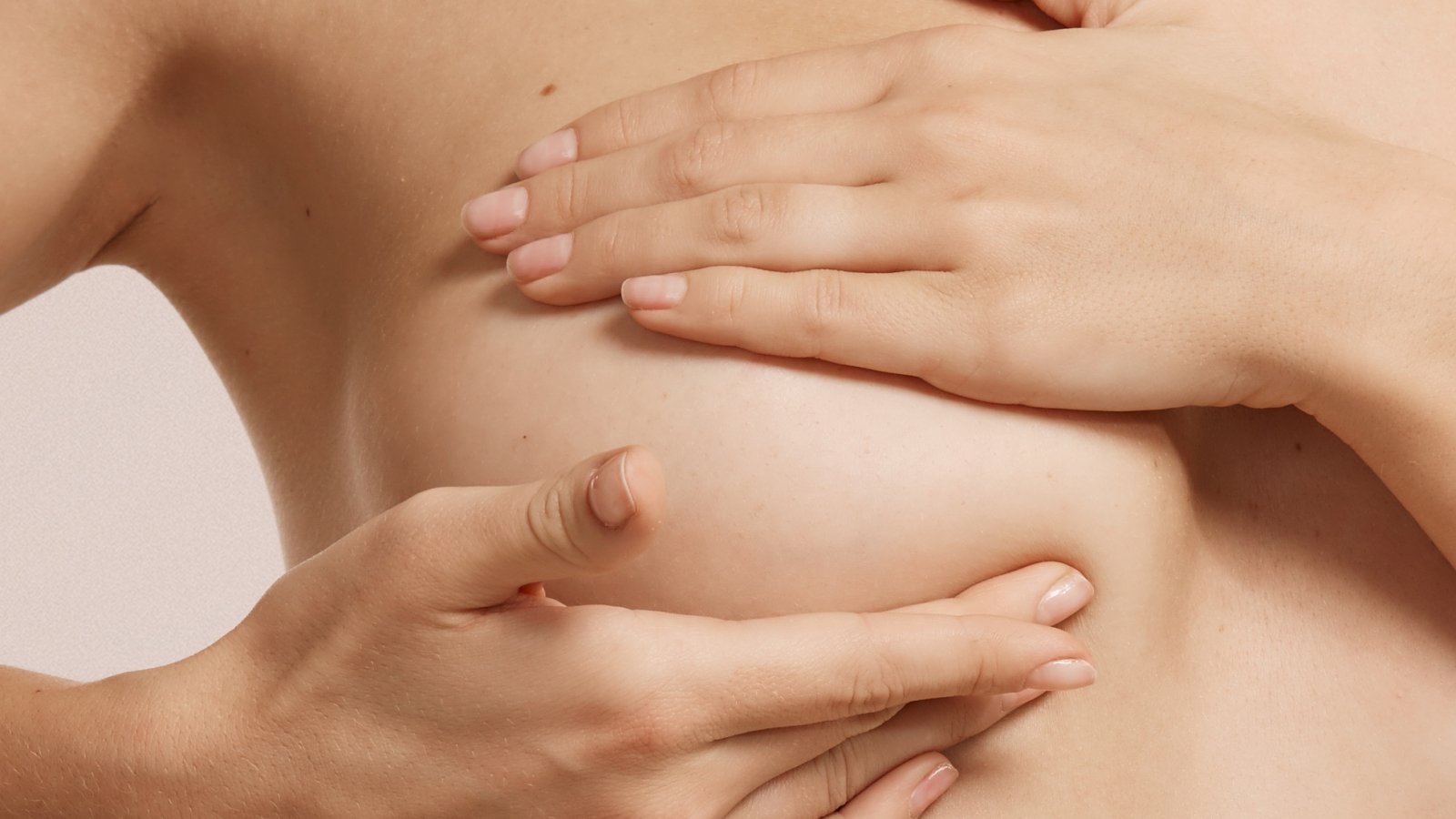 Breast cancer concept - woman checking her breast